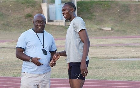 Usain Bolt and his coach, Glen Mills, on the race track