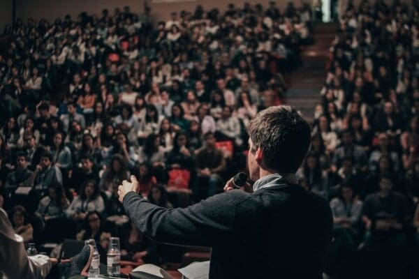 Businessman giving a Ted Talk to a crowd