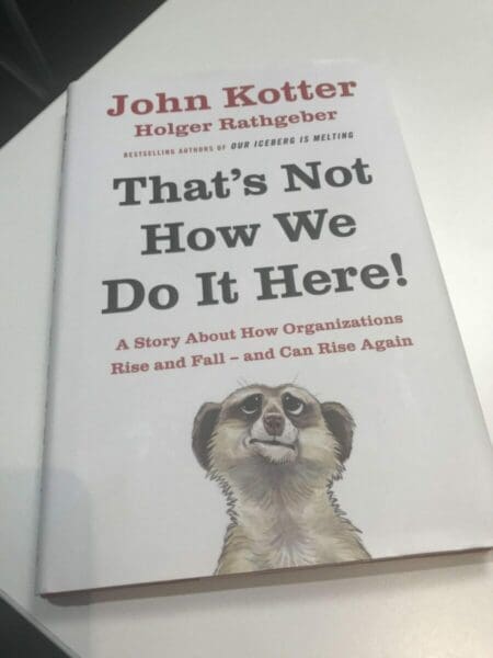 Front cover of That's not how we do it here by John Kotter