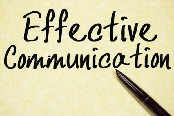 Effective Communication written on yellow background with a brown pen