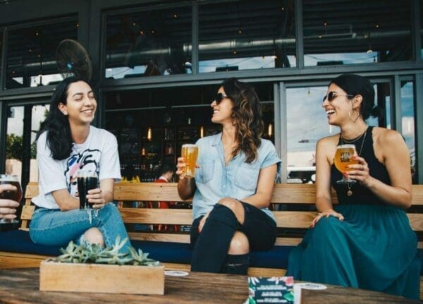 Friends have a good chat over some beer display casual coaching