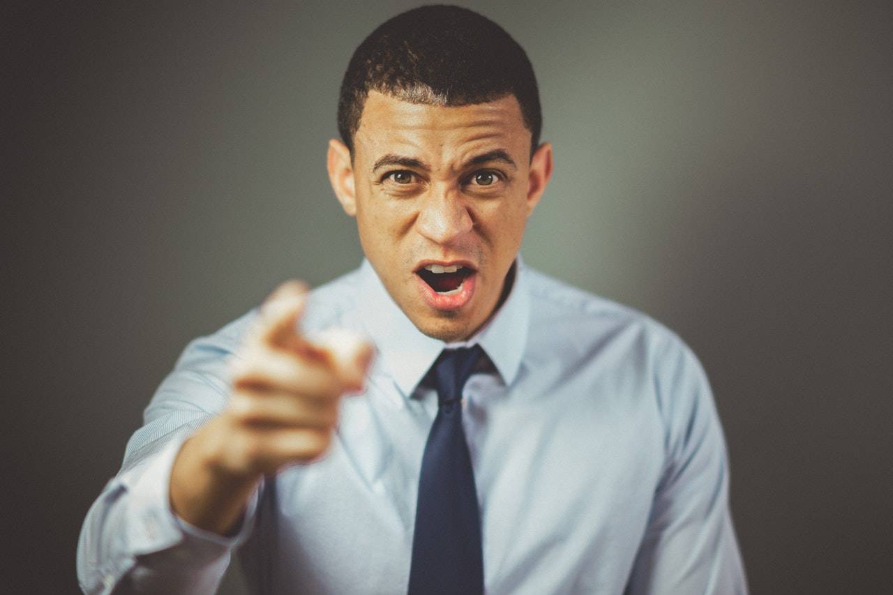 Angry businessman Angry businessman pointing at the camera
