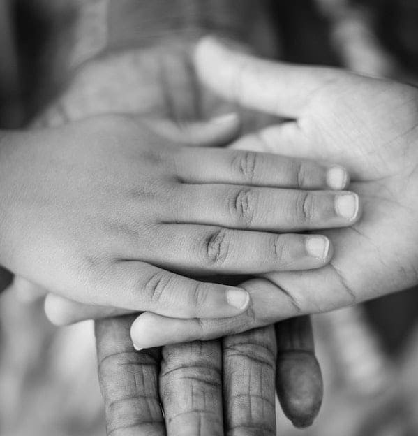 Different hands touching Black and white picture of several hands together