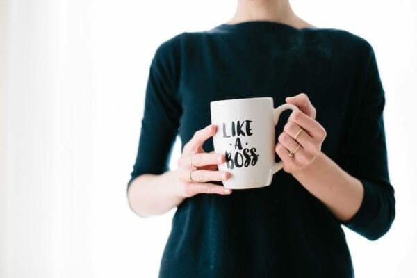 Female manager holding a mug that says Like a Boos