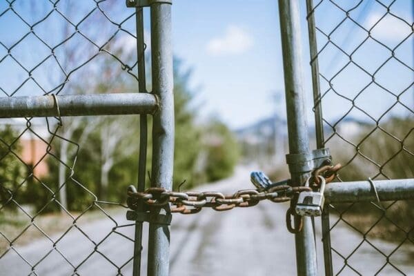 Two metal gates chained together to keep closed representing barriers to effective communication