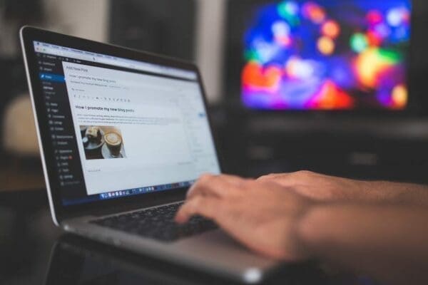 Editing WordPress post Man's hand editing a WordPress post on a laptop