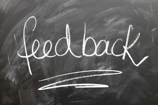 The word feedback written on a blackboard in white chalk