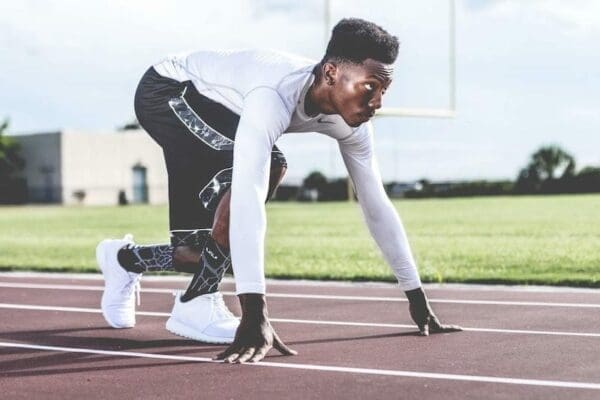 Olympic runner crouching in readiness at the starting line