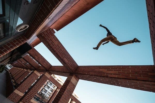 Man parkour jumping over building