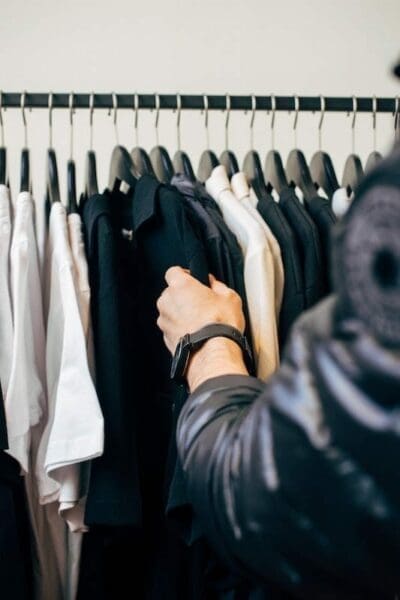 Man browsing through neatly hanged clothes