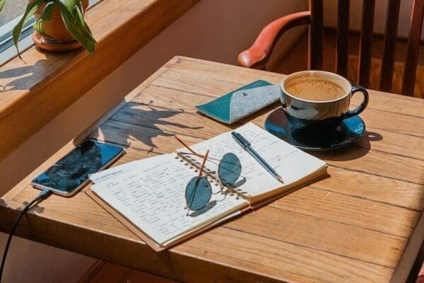 Outside wooden table a diary to note tasks for time management