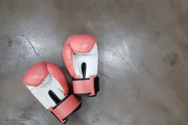 Pair of pink boxing gloves on the floor