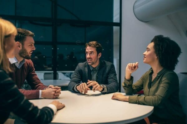 coworkers around a table demonstrating good communications skills