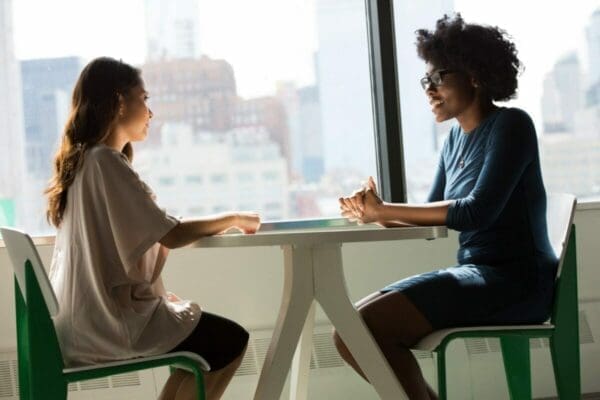 Two women speaking and listening to each other