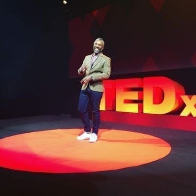 Derek Bruce on stage at a Ted Talk