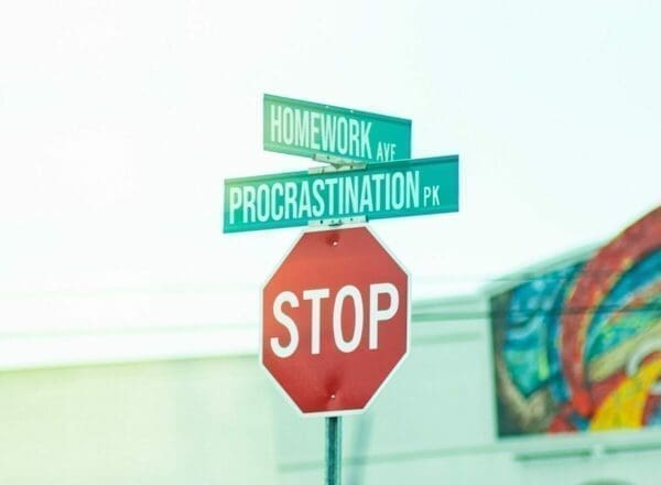 The cross roads between 'homework' and 'procrastination' with a red stop sign below