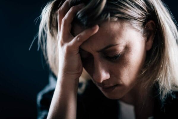 Woman with head in her hands is stressed