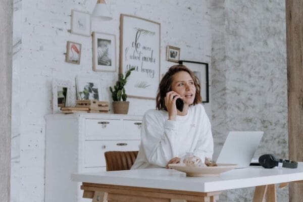 Female manager communicating with her remote team through the phone