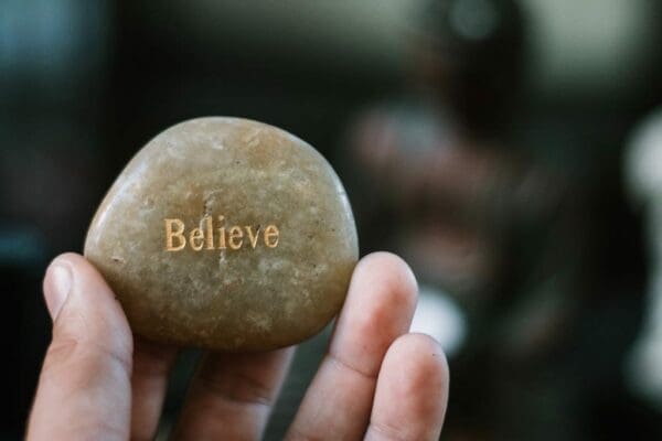 Stone with the word Believe engraved on it