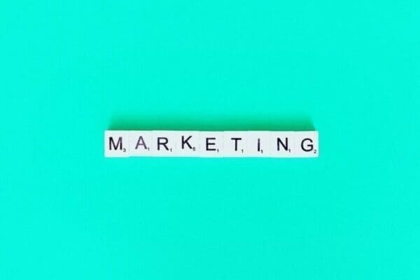 Marketing written in scrabble tiles on light blue blackground