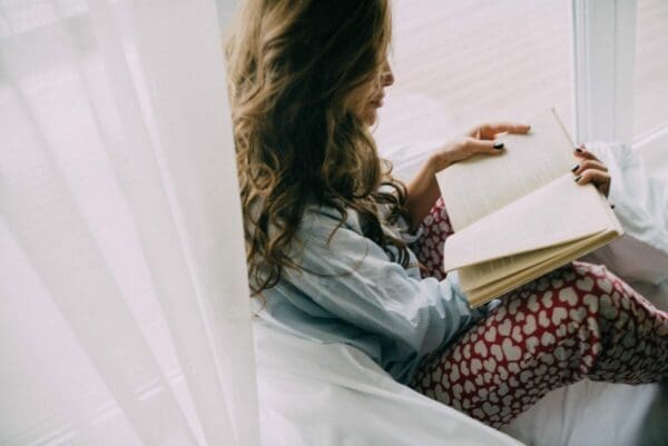 Woman reading a book to improve her communication skill