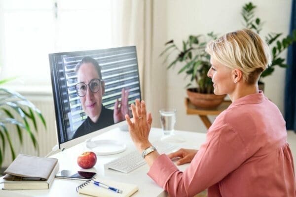 Young businesswoman having video call on computer in home office