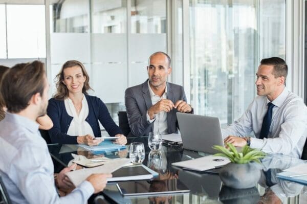 5 business colleagues in a meeting demonstrating people management skills