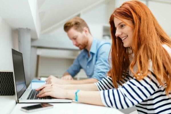 Husband and wife working from home on their laptops