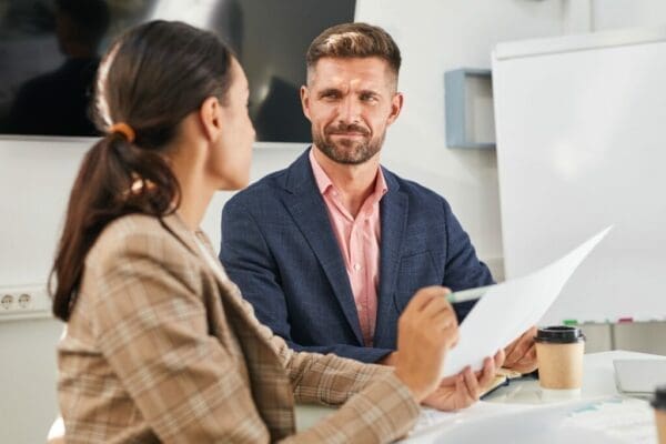 Male manager using people management skills on a female worker