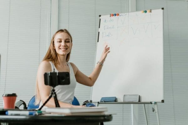 Woman doing a presentation via a video call with white vents background