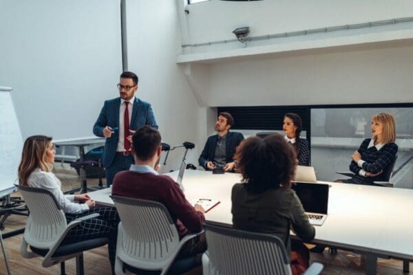 Businesspeople around a meeting table in a board room