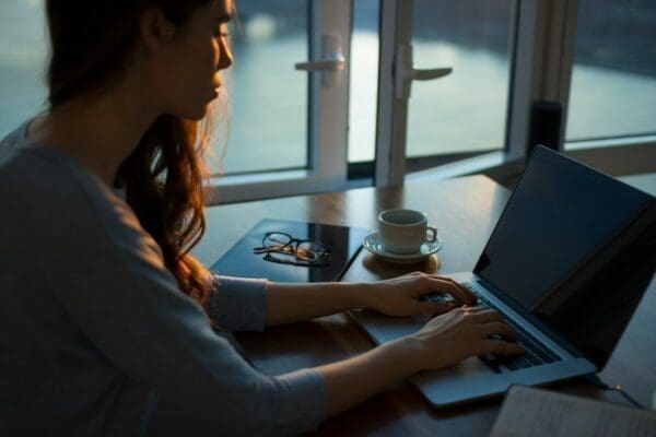 Woman typing on a laptop at her desk