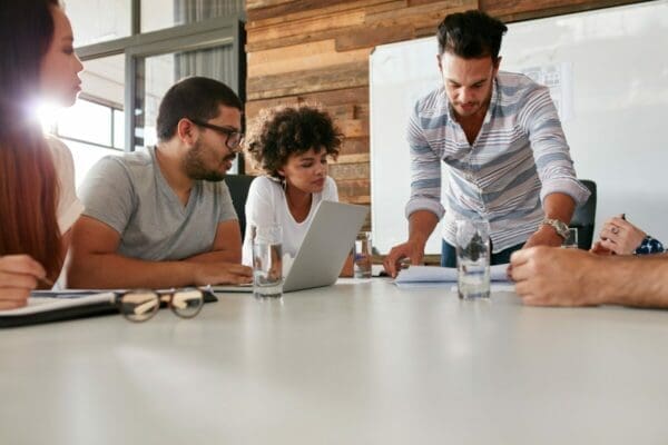 Male leader serving his colleagues by sharing a business plan