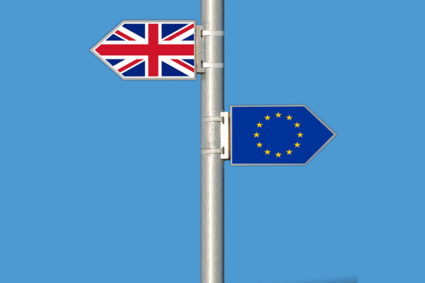 A pole showing the British flag and the European flag in opposite directions representing Brexit