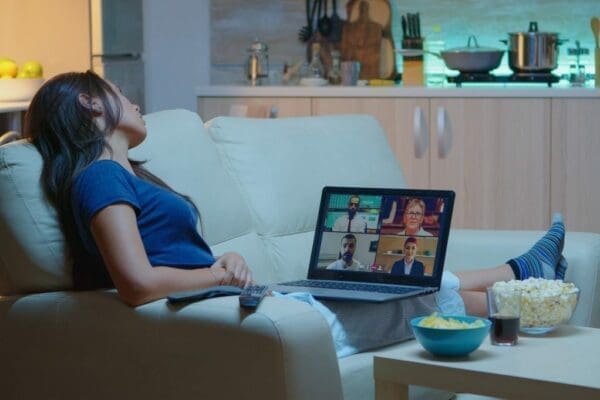 Woman on sofa doing a Zoom meeting