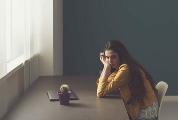 Sad lonely young ENFP woman working at home, overthinking things