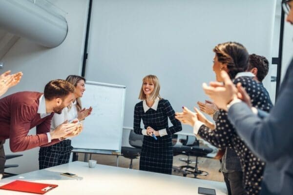 Female presenter getting cheered for her great presentation during a meeting