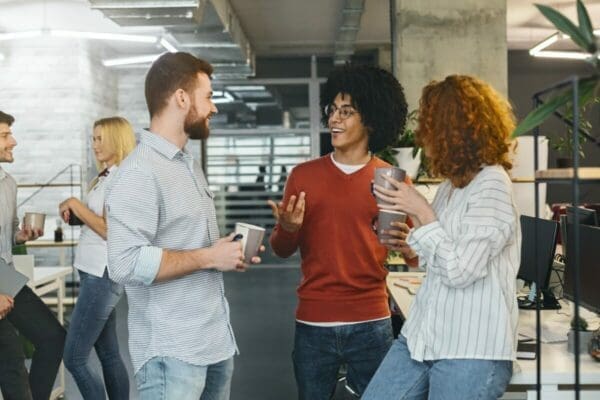 Diverse millennials enjoying communication in modern office