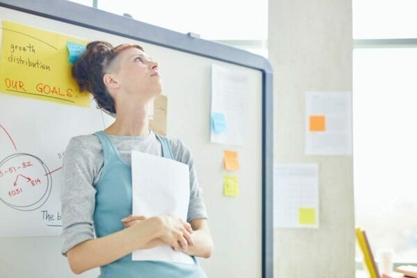 Nervous woman holding papers waiting for a presentation