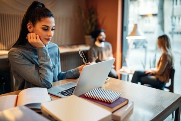 Businesswoman waiting in a cafe with her laptop is learning something new to reduce her nervous energy