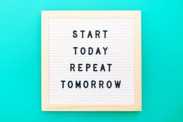 Felt board with start today repeat tomorrow written on it with light blue background