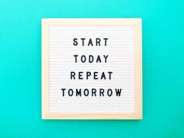 Felt board with start today repeat tomorrow written on it