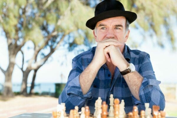Man with chessboard thinking strategically