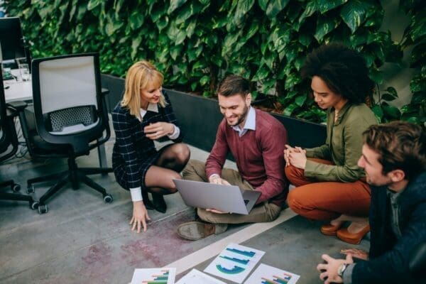 Coworkers on the ground during a brainstorming session outdoors