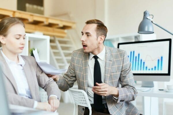 Businessman engaging in difficult conversation with businesswoman