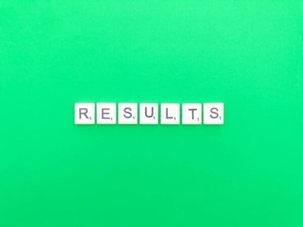 The word results spelt out in Scrabble tiles on a green background