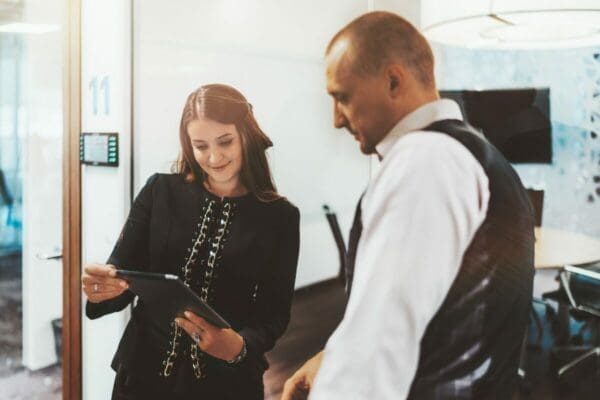 Businesswoman giving feedback to a male coworker