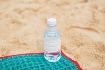 Bottled water on a beach towel for Mistakes Account Managers Make