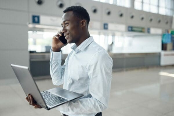 Businessman with phone and laptop negotiating