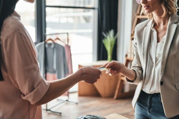 Account manager accepting a credit card from a customer